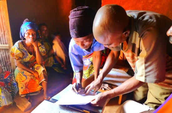 Baraza members witnessing and signing the mediation sheet at Kigongo