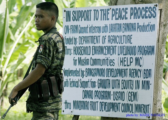 A young Moro rebel standing infront of the sign board at MILF out post, ( A special program from USAID-GEM) inside the MILF Camp Darapanan in Sultan Kudarat, Southern Philippines. Image credit: Mark Navales, https://flic.kr/p/4uaxp 