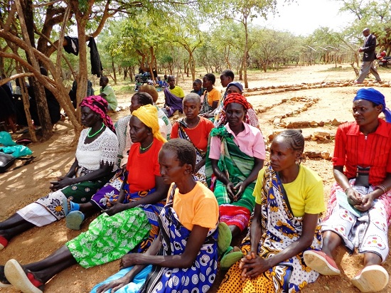 Women at a peace meeting. They are following proceedings while seated, as is traditional. Women play a key role in POKATUSU's work.