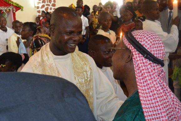 Catholic priest greeting Muslim leader after prayers