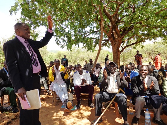A peace and reconciliation meeting between Pokot and Sabiny communities, facilitated by Rev Nahashion (standing). These meetings take place as part of POKATUSU's peace caravans.