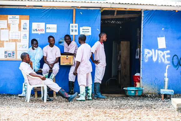 Health workers outside an Ebola treatment centre