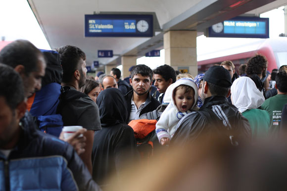 Syrians fleeing the conflict wait board a train in Vienna. Image credit: Josh Zakary